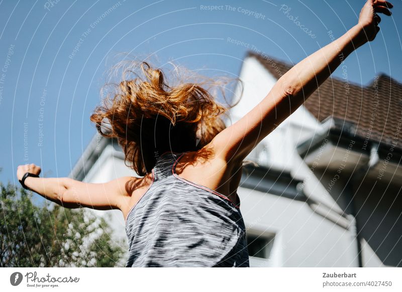 Woman with blowing hair jumps alive with arms raised Young woman Jump Arm cheerful Joie de vivre (Vitality) Sports Summer pretty Joy Happy Energy hooray yoo-hoo