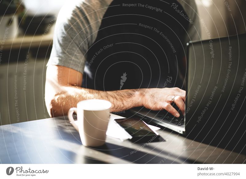 Man sitting at a table at the laptop and typing with his fingers on the keyboard Fingers Keyboard Notebook Typing Internet Digital Modern Technology home office