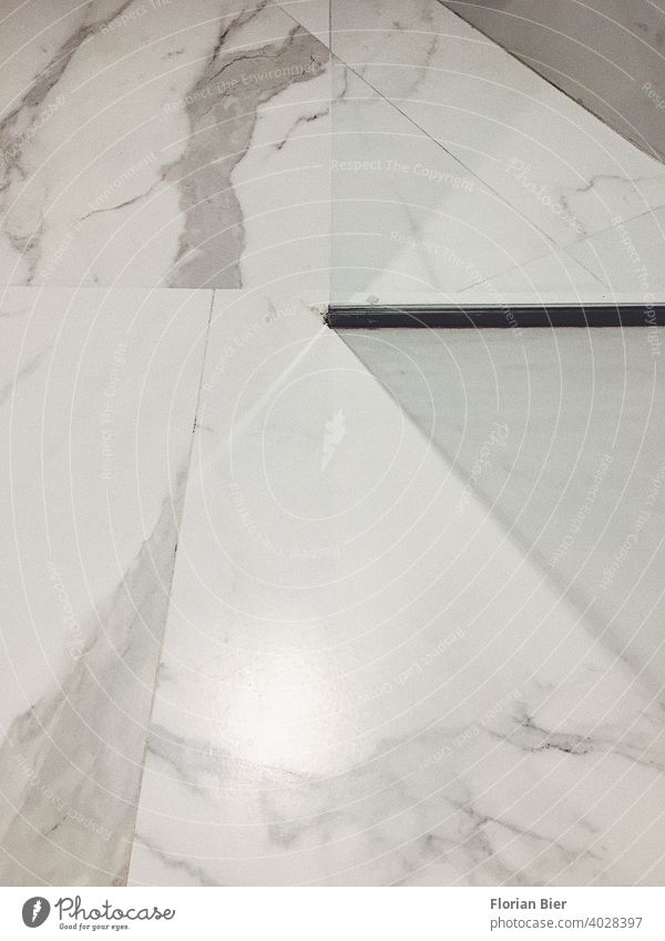 Geometrically laid marble floor in the bathroom with a glass wall for the shower Floor covering Marble Marble floor marbled marbling Stone Pattern graphically