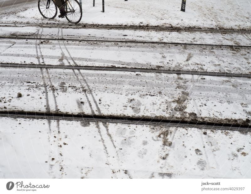 slithering over ice and snow Footprint Snow track Skid marks Snow layer Winter Sidewalk Frost Bicycle cyclist tram Downtown Berlin Cold Street Tracks