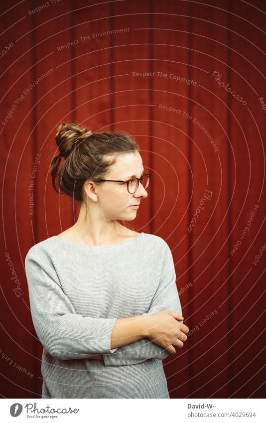 young natural woman with glasses looks thoughtfully to the side Meditative thoughts Woman Student youthful naturally Eyeglasses pretty Blonde Red nerd Girl