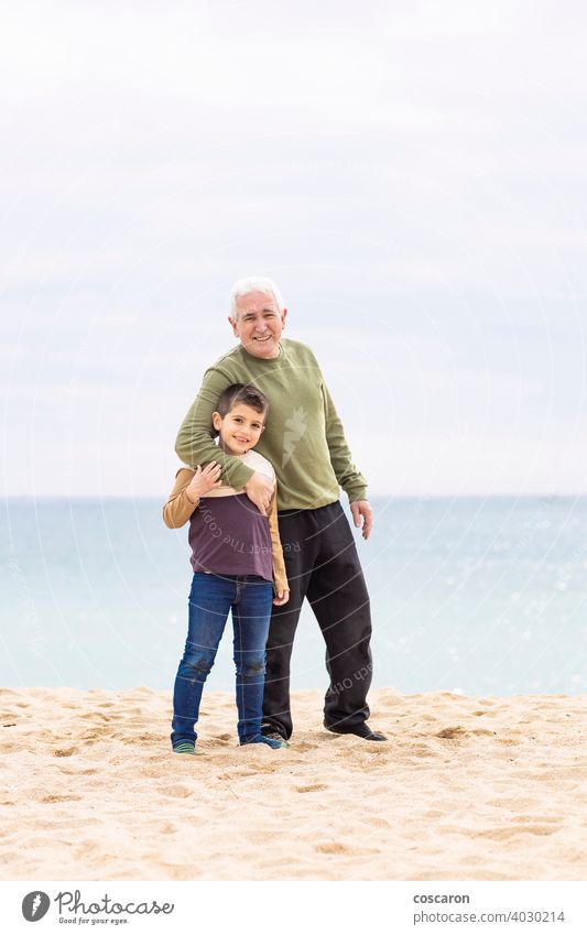 Little boy and his grandfather spending time on the beach baby beautiful cheerful child coast cute enjoying family fun generations girl grandchild grandparent