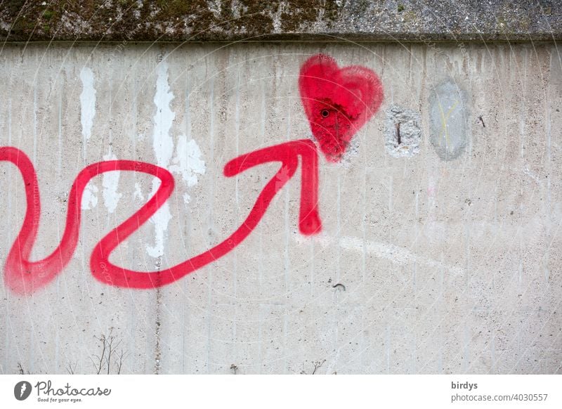 Snake line with arrow at the end points to a red heart on a concrete wall, graffiti, symbol picture Heart Arrow Snakelinein Street art Youth culture Graffiti
