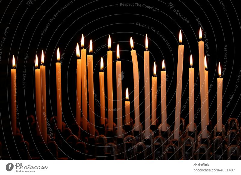 Candles in row against dark background candles Light Shadow darkness Illuminate brightness Church Church service Fear Grief God Christianity Jesus Flame