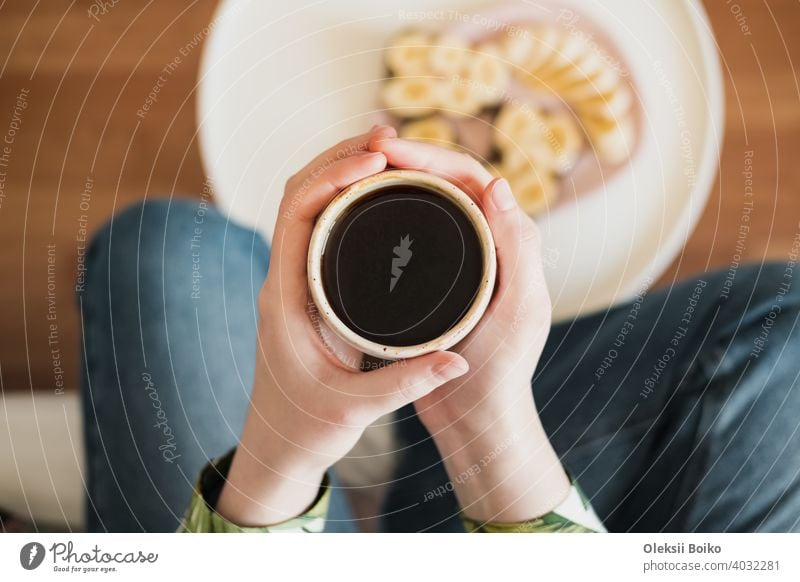 Woman holding a cup of black coffee, shot directly from above. At breakfast, drinking morning coffee at home Parts of body Breakfast Close-up Coffee Cup
