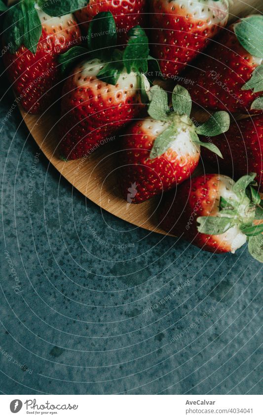 Some strawberries over a wooden plank with delicious aspect strawberry colorful minimalism wallpaper horizontal dieting colours layout patterned abstract half