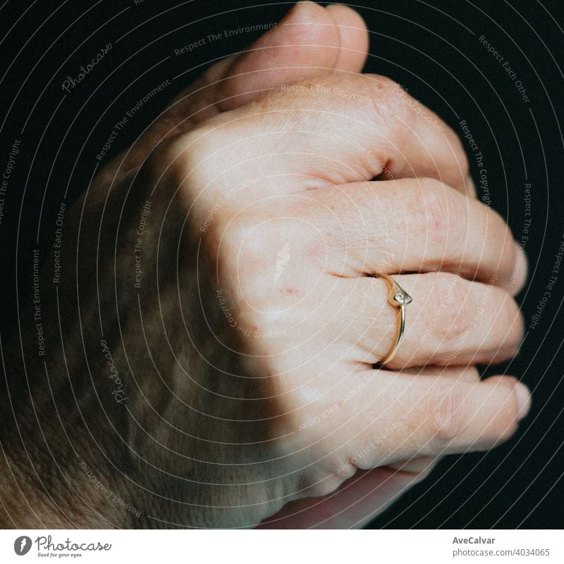 A pair of old hands praying with a luminous ring on the finger, jewelry concept shot person woman diamond feminine fingernail perfection prosperity rich senior