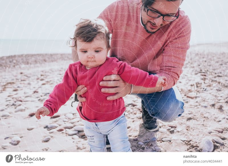 Young dad have a great day at the beach with his dauther family baby holidays happiness happy family time real people kid child little girl sunny father parent