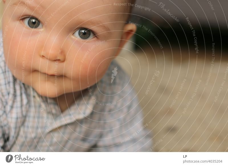 beautiful baby looking very serious into the the camera puzzled Perplexed sceptical scepticism doubts Doubt hestitate uncertainty confusion Infancy reality