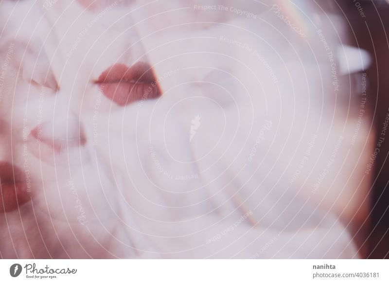 Distorted image of a young woman face view througn a prism beauty abstract lips makeup make up reflection reflected distortion distorted blur blurry focus