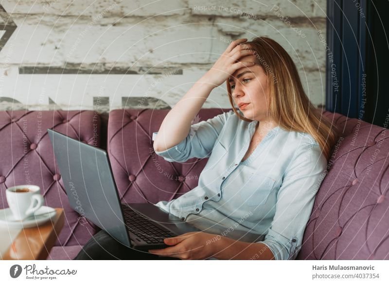 woman with headache working on laptop, stressful work, bad news via e-mail adult back posture bad posture beautiful business businesswoman casual caucasian