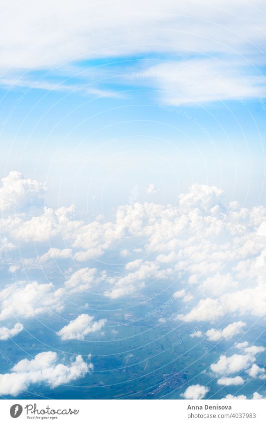 Skyline View above the Clouds from Airplane sky airplane cloud view blue window white high travel fly beautiful background horizon space flight atmosphere