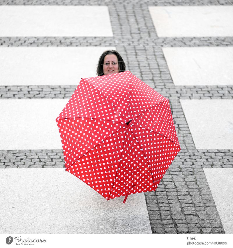 Woman behind umbrella ahead Umbrellas & Shades Head Hide Places Stone path inquisitorial Smiling lines Red Whimsical Sunshade