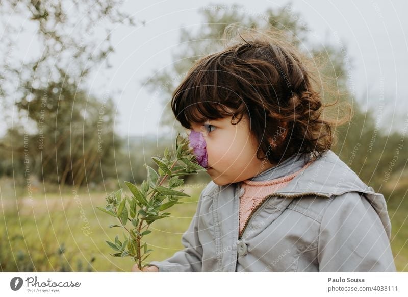 Child smelling wild flower childhood 1 - 3 years Caucasian Curiosity Education Life Happy Playing Day Childhood memory Leisure and hobbies Colour photo