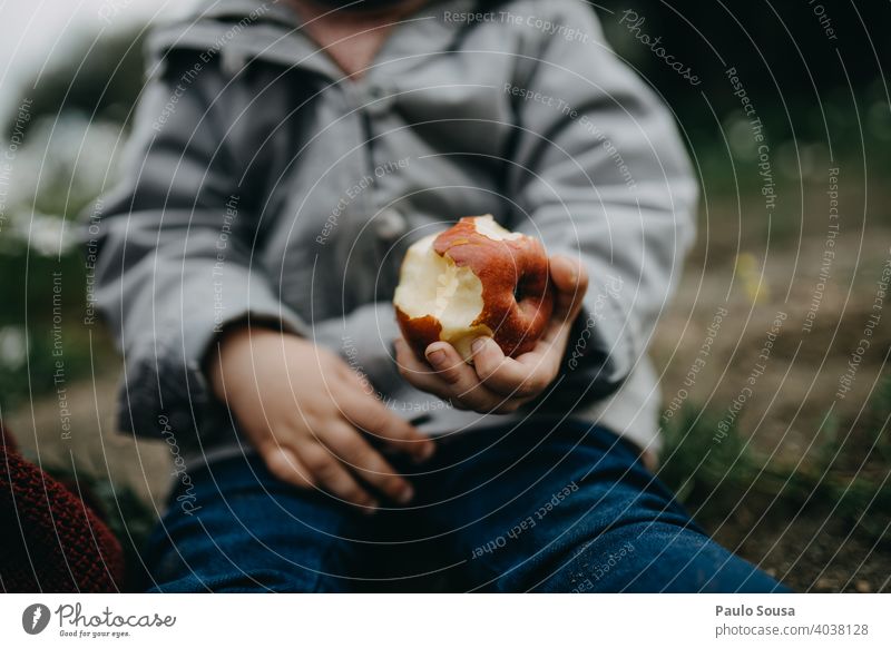 Close up child hand holding an apple Apple Child Eating Colour photo Exterior shot Nutrition Healthy Organic produce Day Apple tree Food Authentic Fruit