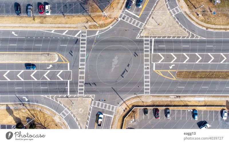 Aerial view of an intersection with vehicles aerial view auto automobile avenue busy car chaos city city street commercial connection crossing crossroad