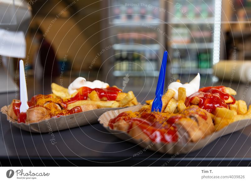 Two curry sausages with chips, ketchup and mayo Prenzlauer Berg Berlin Snack bar Town Exterior shot Hotdog French fries Deserted Downtown Colour photo Day