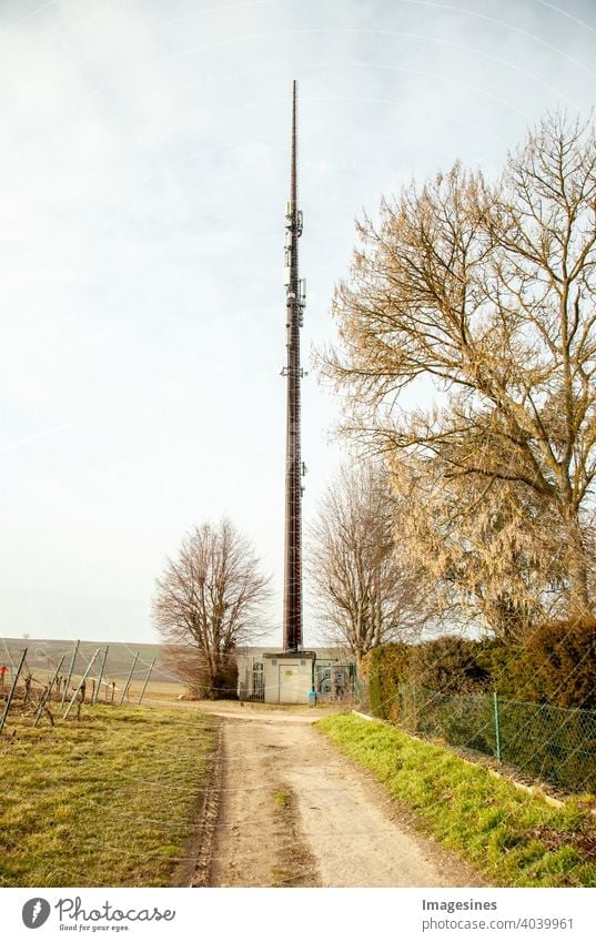 Old concrete transmission mast in the vineyards near a residential area in Germany, Rhineland-Palatinate, Saulheim. Radio - transmission mast obsolete Concrete