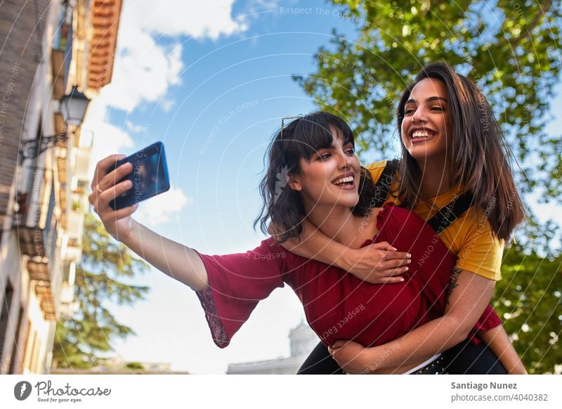 Two teenager girls taking a selfie. madrid young people friendship lifestyle beautiful fun happy together leisure woman smiling teens cheerful female youth