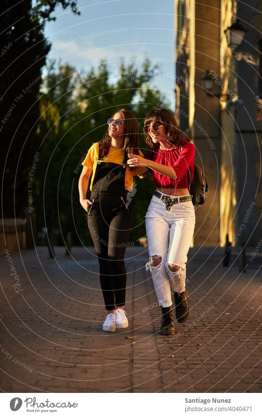 Two teenager girls walking down the street. madrid young people friendship lifestyle beautiful fun happy together leisure woman smiling teens cheerful female