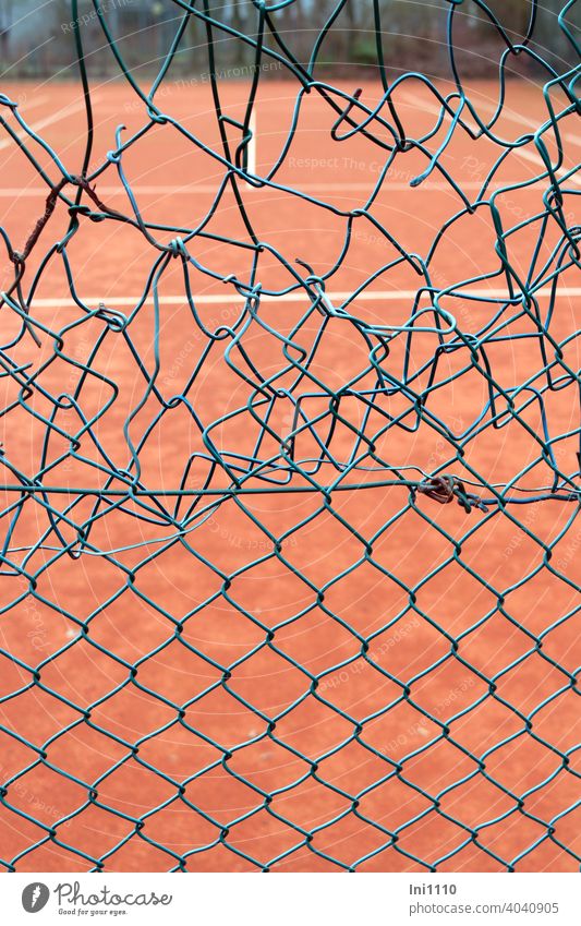 Tennis court unprofessional repair to the wire mesh fence Wire netting fence grid wire mesh damage Repair makeshift Green Turquoise Playing field Hollow Damage