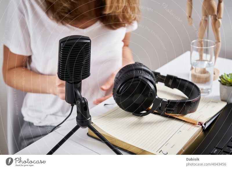 Podcast concept. Woman recording online course microphone headphones workplace podcast audio radio technology top view keyboard remote education learning