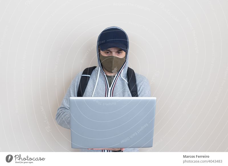 man with laptop in hands and mask technology hygiene virus protection standing business man in mask facemask health care laptop holding in his hands notebook