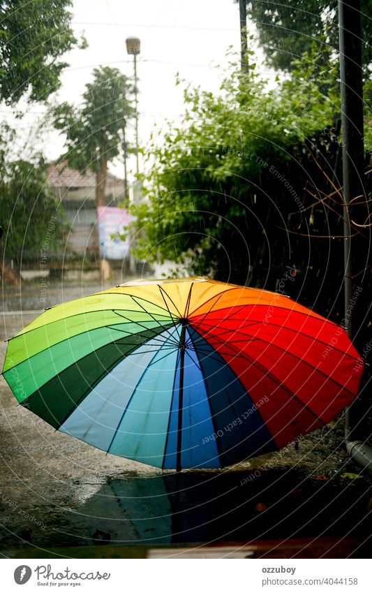 colorful umbrella on rainy day weather season wet outdoor water drop background nature protection raindrop fall storm outside spring safety blue climate red