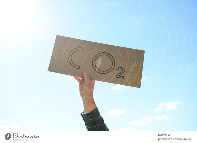 CO2 - Man holding a sign in the air co2 environmental activist CO2 emission Environment sustainability Climate change Environmental protection