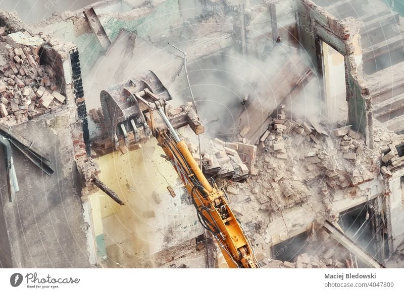 Building demolition in progress, view from above. building destruction industry excavator rubble wall work machinery equipment construction site house