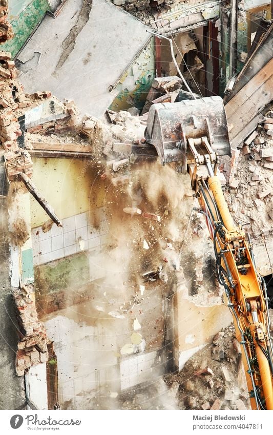 High angle view of a building demolition in progress. destruction industry excavator rubble wall work machinery equipment construction site house dismantling