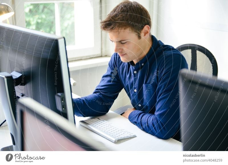 Young man working on PC in office Freelance work Computer Use of the laptop Hipster Technology Wireless Millennia more adult people masculine job Success person