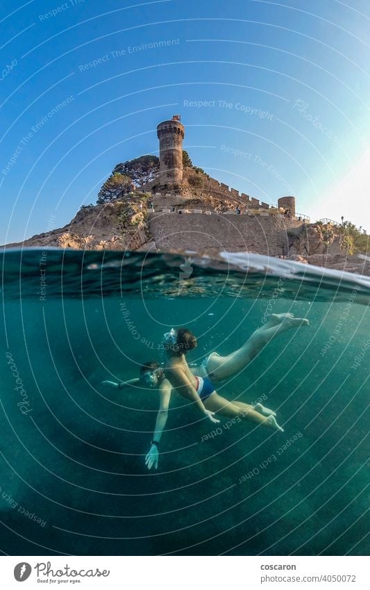 Mother and son snorkeling with a castle in the background active apnea beach boy caribbean child childhood cute dive diver enjoying enjoyment exploration fun