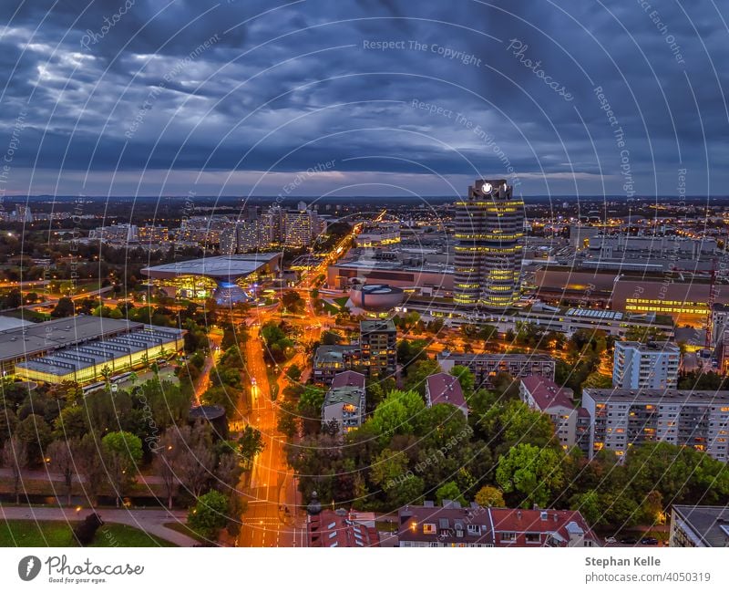 Wonderful twilight view over the illuminated Munich with business district and cars on a road from a high perspective. german southern germany top bavarian