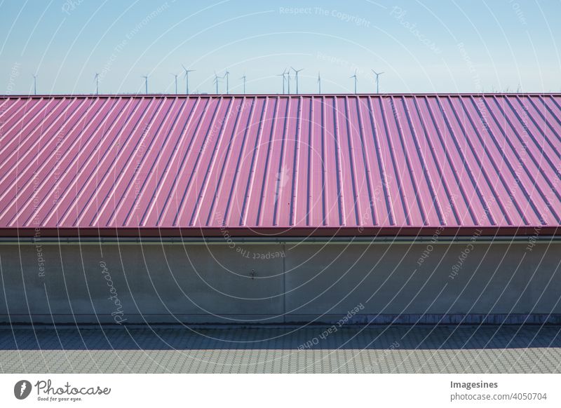 Industrial hall. Exterior view of roof structure and wind turbines in the distance. Industrial hall, machine hall Germany construction sector Storage Factory