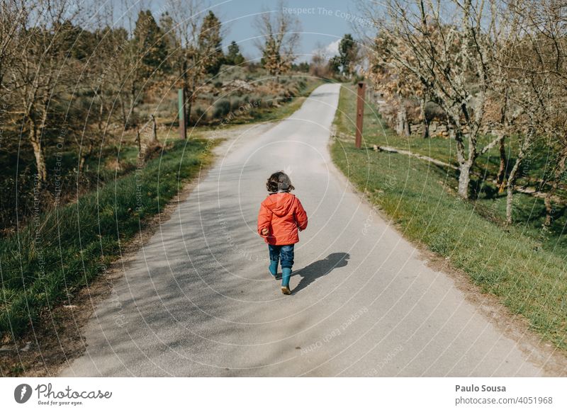 Rear view child walking on the road Child Walking Empty Landscape Vacation & Travel Nature Adventure Trip Sky nature Tourism trip Exterior shot scenery Freedom