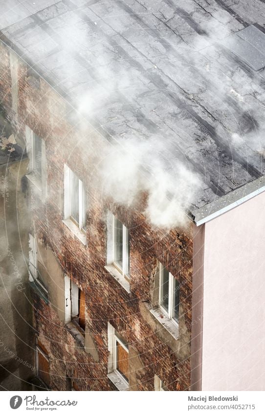 Fire of an old townhouse building, view from above. fire smoke city aerial danger fear insurance accident poisonous residential risk burn roof destruction