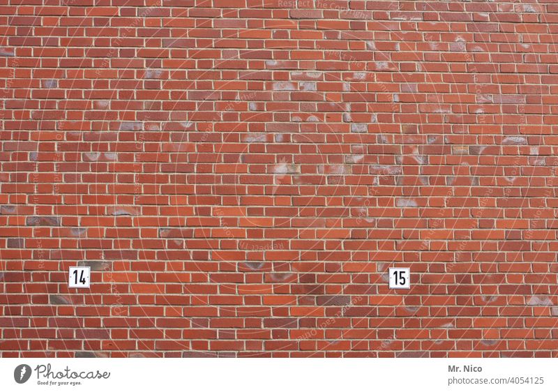 14 and 15 Digits and numbers Signs and labeling Wall (building) Wall (barrier) Facade Brick wall mark Red Information Characters Arrangement Orderliness