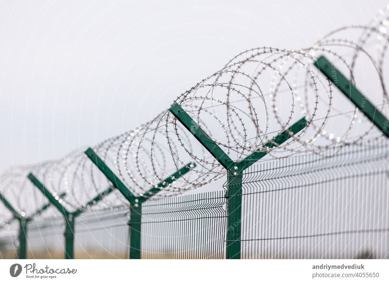 Fencing of sensitive sites with barbed wire. Barbed wire. Restriction of freedom. Prison fence. Forbidden territory. The concept of security. The concept of the ban.