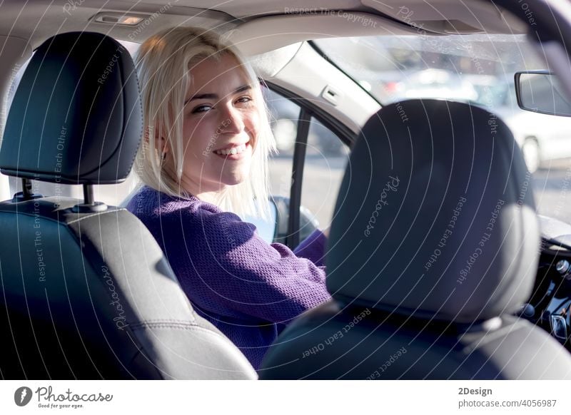 Young smiling woman steering car at sunset person hire hiring insurance owner safety successful test driver happiness joyful leasing looking pleasure purchase