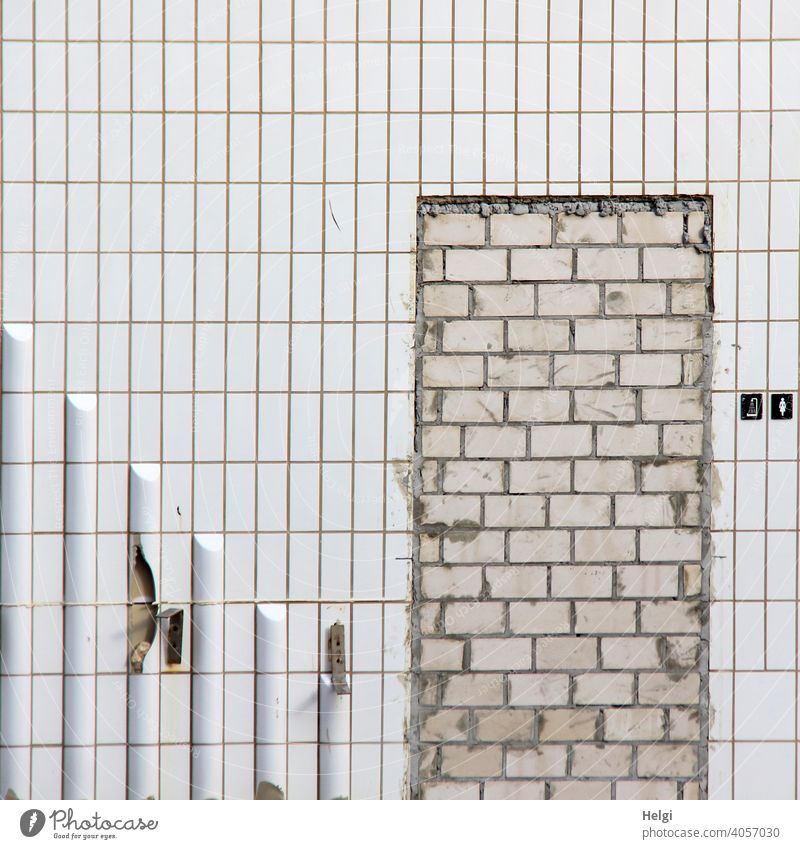 locked out - bricked up passage to shower for ladies , wall with white tiles , remains of a demolished swimming pool Wall (building) Wall (barrier) no passage
