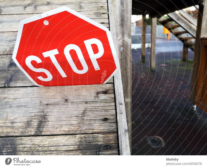 Stop sign stuck in the gap between two boards on a climbing frame at the elementary school in Wettenberg Krofdorf-Gleiberg near Giessen in Hesse, Germany stop