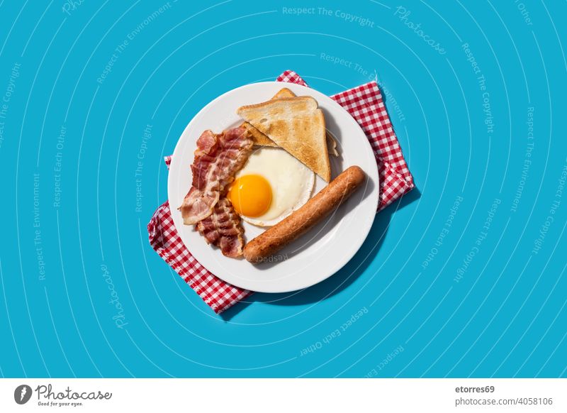 Traditional American breakfast on blue background amrican bacon bread dish egg fat food fried nutrition plate protein sausage
