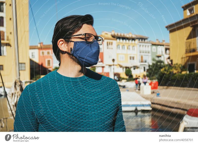 Young man wearing a face mask enjoying a sunny day in Alboraya, Valencia, Spain male holidays summer covid coronavirus flu influenza spain coast water