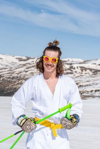 Skier dressed as a karateka at a ski station Sports action active activity adventure artistic beautiful cold cool costume downhill extreme extreme skier fast