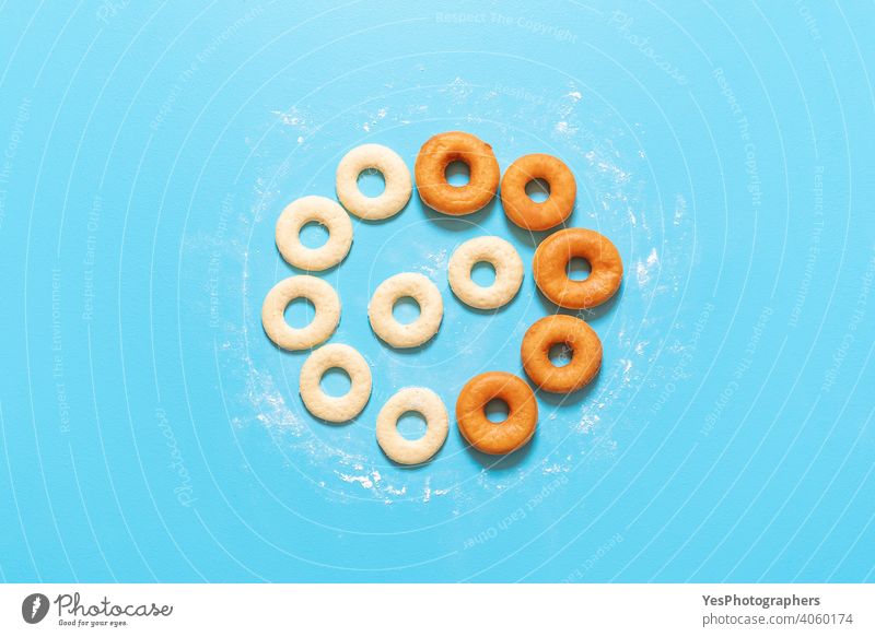 Cooking doughnuts process. Homemade dough and deep-fried donuts, top view aligned american blue background breakfast cake circle shape comfort food