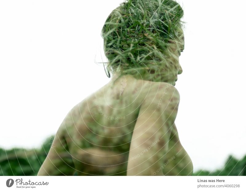 Double exposure image of a young and beautiful girl. Her gorgeous profile is mixed with the green grass of summer. Creative and expressional way to look into women’s and nature's beauty altogether.