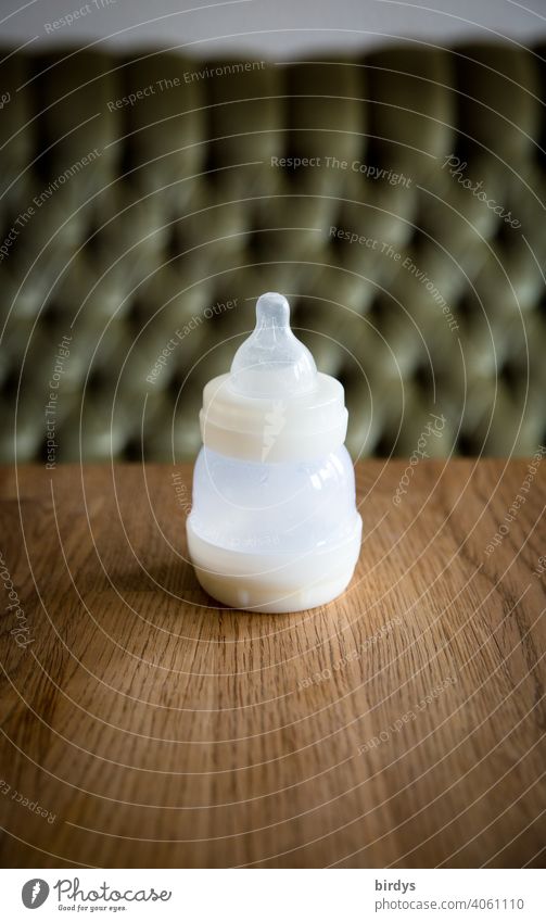 Baby bottle with teat on a wooden table. Baby's bottle Baby food Infant formula Infancy Bottle feeding Nutrition Infant Feeding Milk bottle suction cup