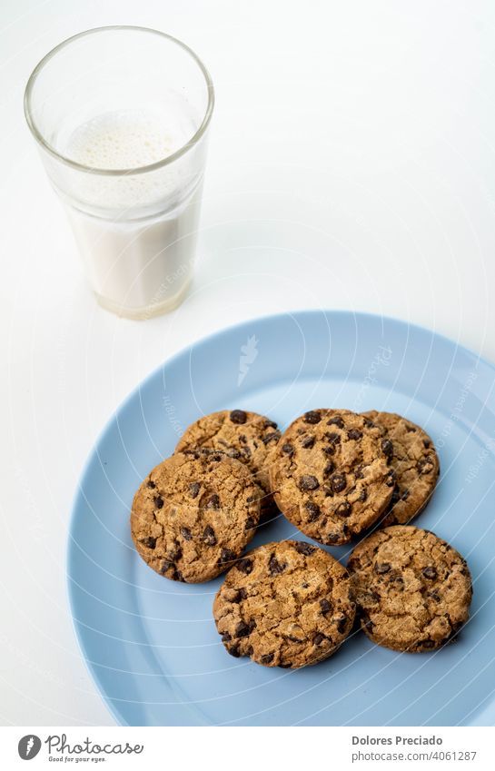 Plate of chocolate chip cookies and a glass of milk Breakfast Milk Natural drink sweet food biscuit Colour photo meal wooden domestic pastry yummy dairy