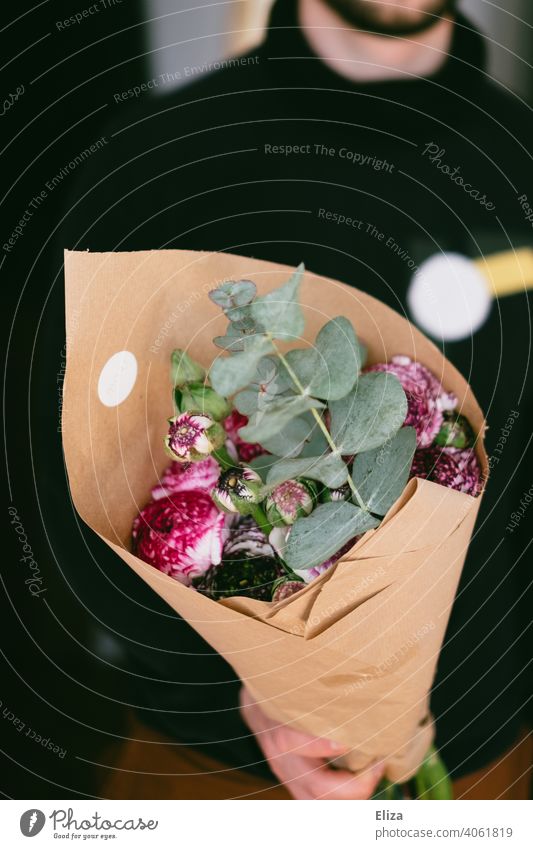 Man holding a bouquet of flowers Bouquet Ostrich eucalyptus Ranunculus Paper stop Mother's Day Valentine's Day purple souvenirs attention Gift